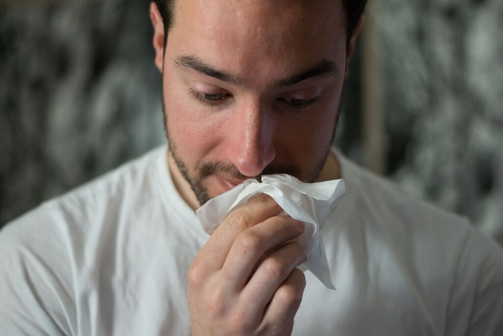 Man blowing nose