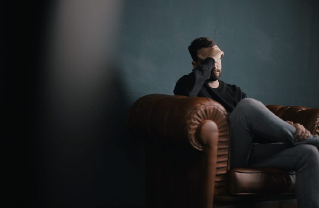 Man having migraine on the couch