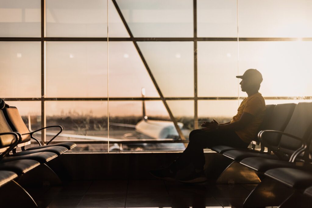 A silhouette image of a man in an airport