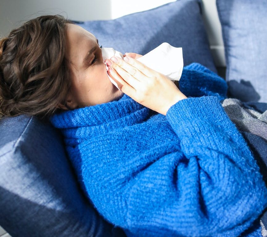 Woman blowing her nose