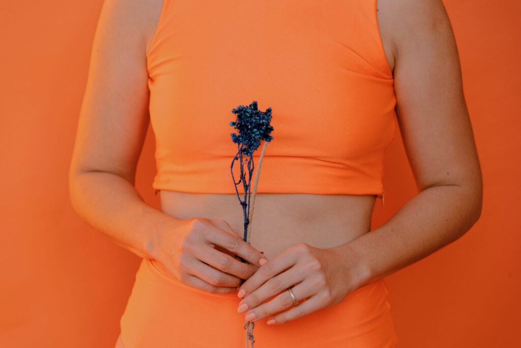 Woman wearing orange with flower